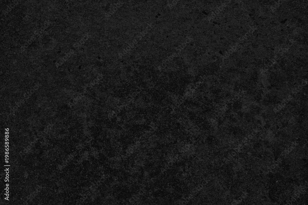 Fototapeta premium Dark textured background with a rough, grainy surface in deep black tones