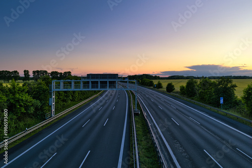 Empty German Autobahn Highway at Sunset with Gantry Sign and Scenic Horizon - real photography - authentic - no ai - True Long Exposure