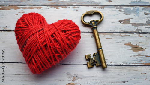 hand crafted red heart and old vintage key on wooden table top view.ai 