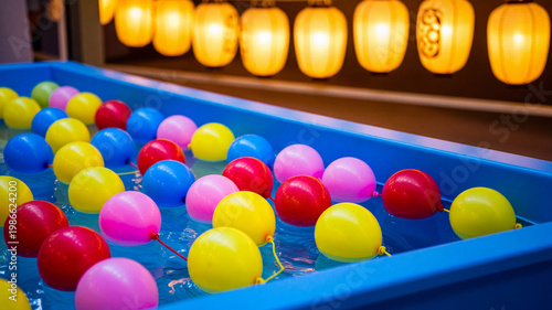 Vibrant Japanese Summer Festival Yo-Yo Water Balloon Stall Background with Copy Space