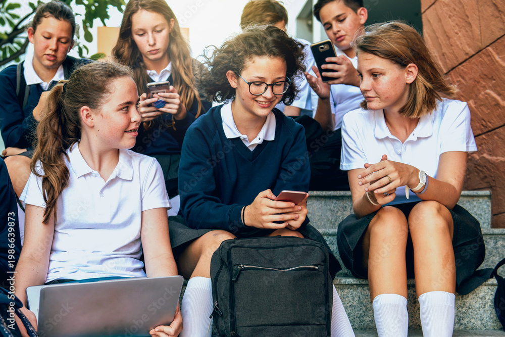 Fototapeta premium Students using technology outdoors photo