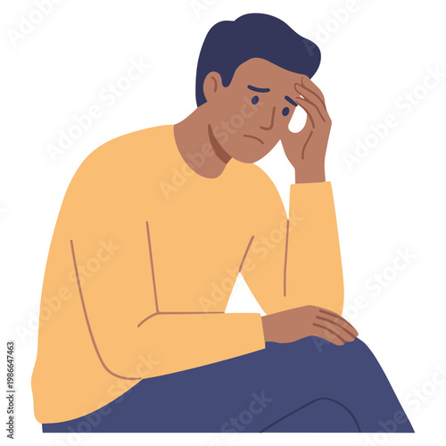 A man sits dejectedly with his hand on his forehead expressing sadness