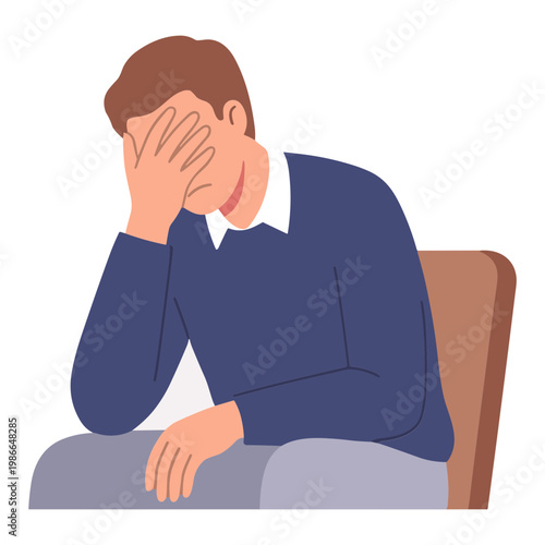 A man sits on a chair covering his face with his hand expressing sadness