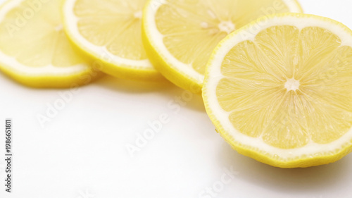 Fresh Lemon Slices with Water Droplets on White Background and Copy Space