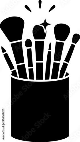 Large set of professional makeup brushes in container with decorative rays and sparkles.