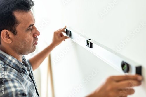 Photography Man using level tool indoors