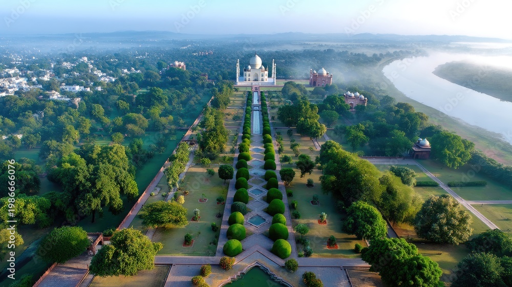Fototapeta premium Aerial View of the Taj Mahal Surrounded by Lush Green Gardens and River at Dawn with Mist in the Air