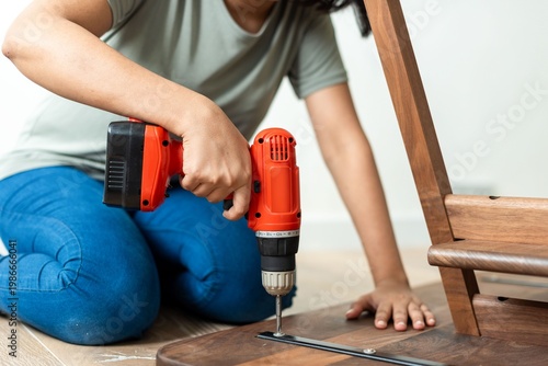 Canvas Print Person assembling wooden furniture indoors