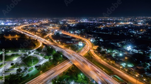 Nighttime Traffic Flow Overhead View of Cityscape with Illuminated Roads and Urban Lights