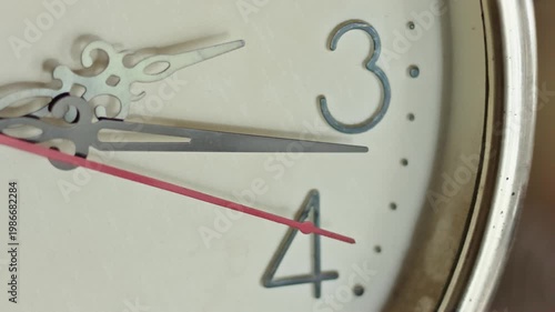 Extreme Close Up of Vintage Wall Clock With Second Hand Ticking Past Numbers Three and Four