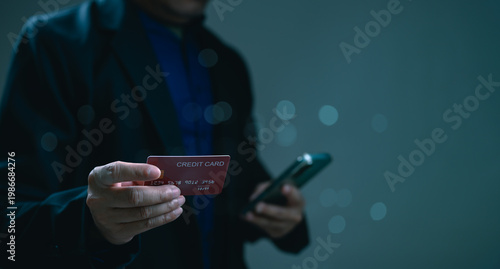 Photos Businessman holding credit card plus smartphone performs secure digital transaction online
