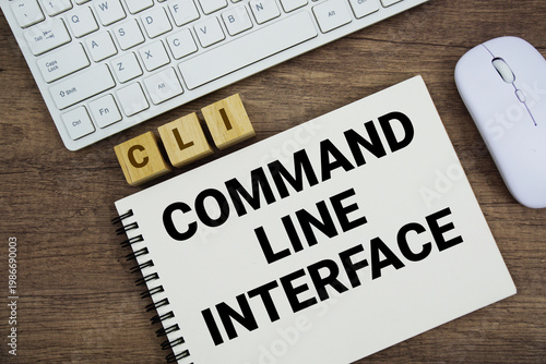 Canvastavla CLI Command-Line Interface message with keyboard and optical mouse on wooden bac