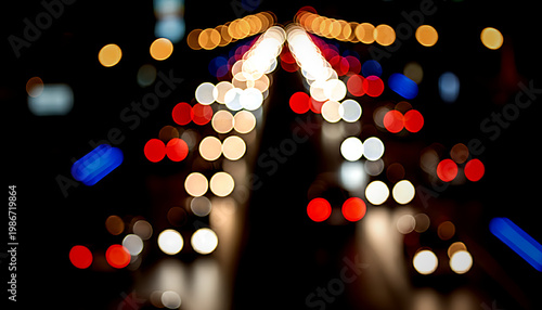 Blurred image of a road with colorful traffic lights at night