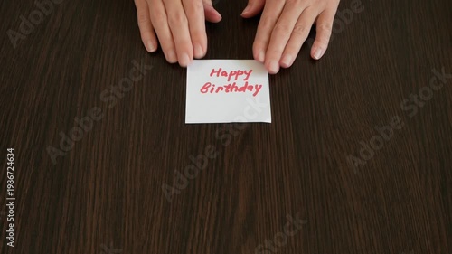 Zefir or marshmallows as pink rose, red car model and happy birthday card in hand, Concept