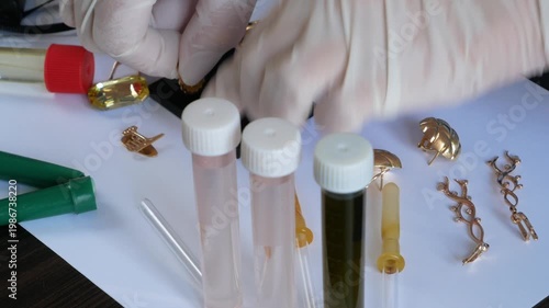 Pawnshop worker verify golden jewelry on many golden and silver jewelleries, scales and money background. Customers Buy and Sell Precious