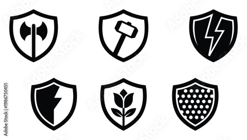 Versatile collection of monochrome shield insignias displaying powerful symbols like an axe hammer lightning and floral motif suitable for app interfaces gaming elements or security