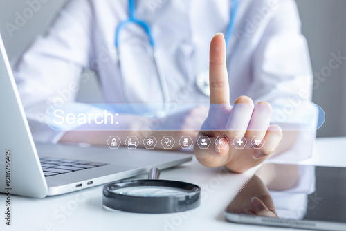 Fotografie Health professional interacting with a search interface on a computer at a clini