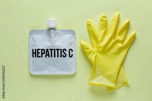 A medical glove and a bag marked Hepatitis C on a surface
