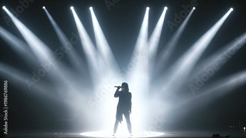 Singer performing on stage in bright spotlights.