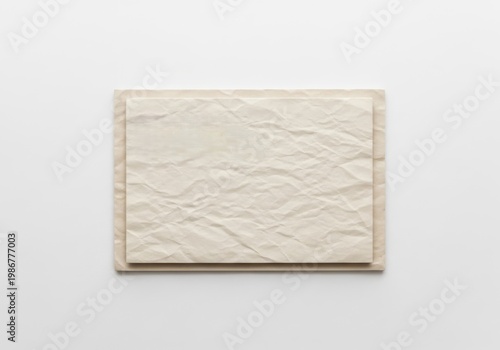 A small white rectangular tile with a textured surface