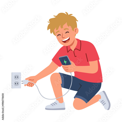 A boy is happily charging his phone from a wall outlet.
