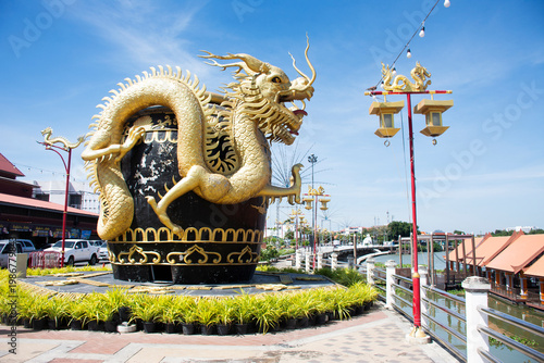 Art symbol of big large Rat Buri city glazed water jar and sculpture carving golden dragon riverside Mae Klong river for thai people travelers travel visit on November 21, 2025 in Ratchaburi, Thailand