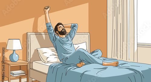 Young bearded man in blue pajamas sits on his bed and stretches his arms while waking up in a sunlit bedroom in morning.