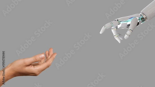 Futuristic video intro of human hand and robotic mechanical arm reaching towards each other, isolated on gray background with copy space.