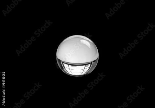 Shiny metallic spherical object with a subtle grid pattern on its surface