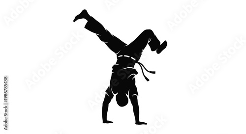 Silhouette of a martial artist performing a handstand against a white background