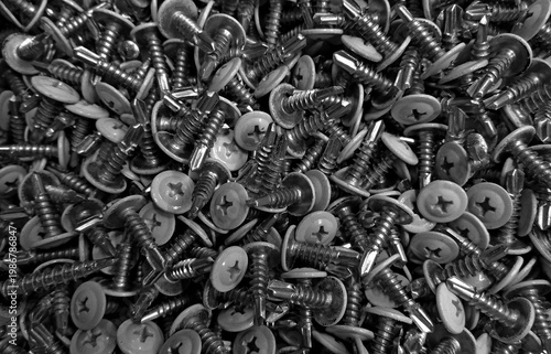 Heap Of Self Drilling Screws With Flat Heads Scattered Surface 
