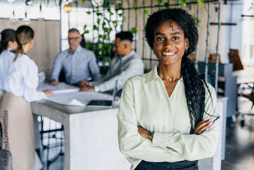 Obraz na plátne Confident female leader directing modern workspace team dynamics