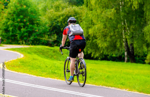 Wallpaper Mural Cyclist ride on the bike path in the city Park Torontodigital.ca