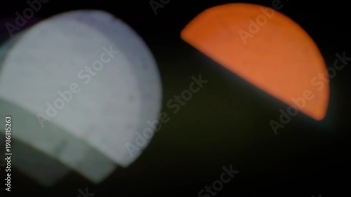 Abstract Cinematic Bokeh Background with Glowing Orange and White Geometric Light Shapes on Dark Background