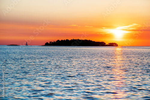 Incredibly beautiful romantic landscape with with a sailboat at sunset at sea between the islands (vacation, rest, harmony, meditation, honeymoon - concept)