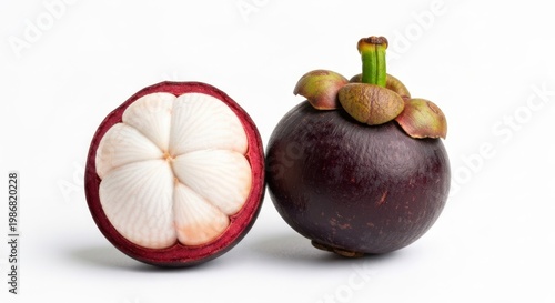 Purple queen of fruit, one halved, showing white segments, on white backdrop