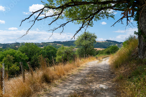 Hiking trail through the rural countryside of Aveyron, France, scenic nature path
