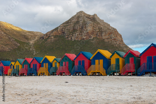 The iconic colorful beach at Muizenberg Beach, located near Cape Town on False Bay, is world-famous for its iconic huts, excellent and safe surfing conditions for beginners, and warmer water. It is th