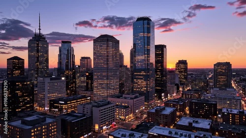 Modern Cityscape at Dusk with Illuminated Skyscrapers and Dramatic Sky