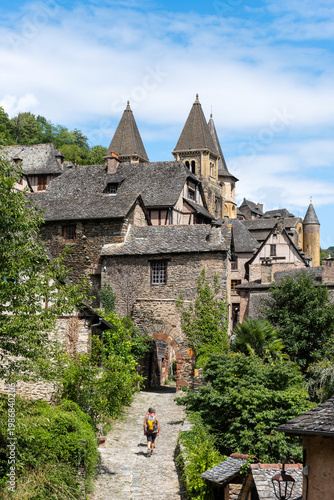 Historic cobblestone streets and medieval buildings in Conques village, Romanesque church, France