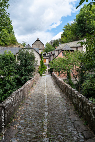 Ancient stone bridge at the entrance of the medieval village of Conques, Aveyron, France