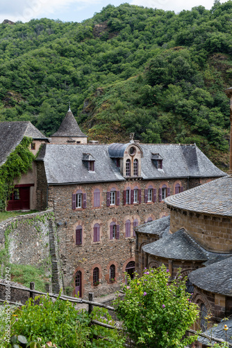 Historic cobblestone streets and medieval buildings in Conques village, Romanesque church, France
