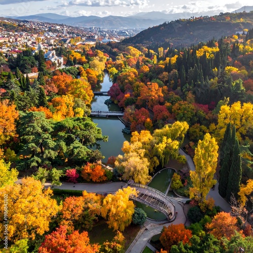 Aerial view of vibrant autumn park with winding river and bridge