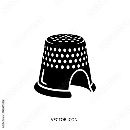 A black thimble with white dots on it