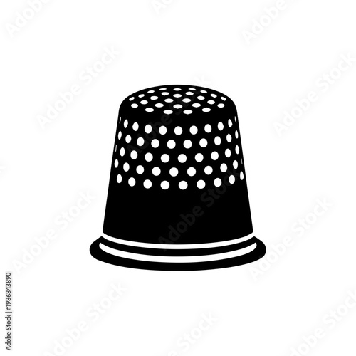 A black thimble with white dots on it