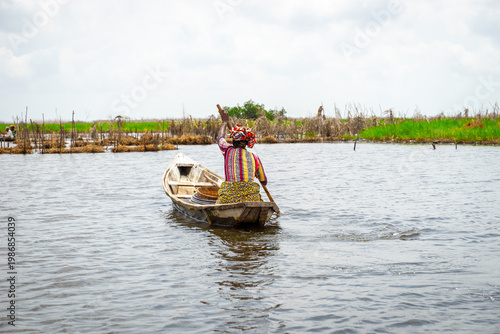 Fishermen in a small boat at lake Nokoué in Benin, West-Africa