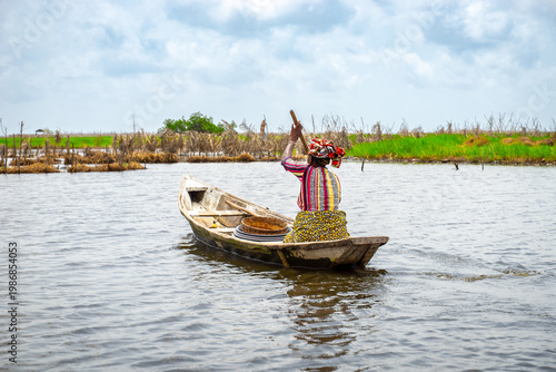 Fishermen in a small boat at lake Nokoué in Benin, West-Africa