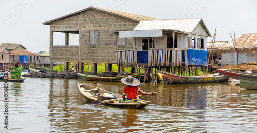 Fishermen in a small boat at lake Nokoué in Benin, West-Africa