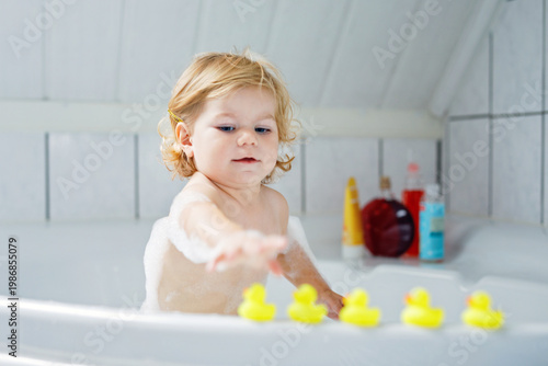 Принти на полотні Adorable cute little toddler girl taking bath in bathtub