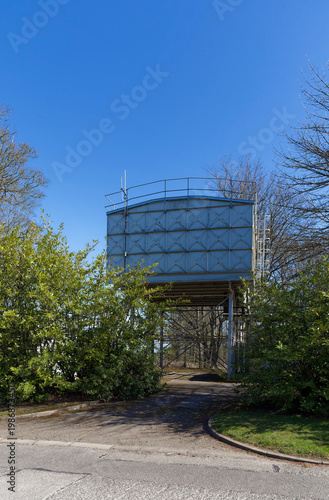 The Historical Steel raised Water Tanks at Stracathro Hospital Entrance hidden behind the bushes and Trees on a clear Spring day.